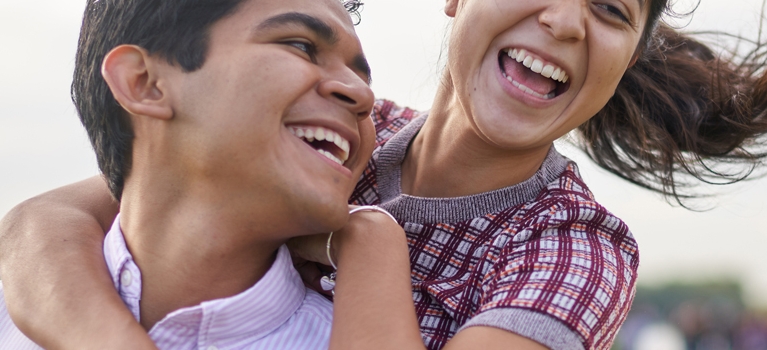 Young Woman Laughing With Her Boyfriend In A Park