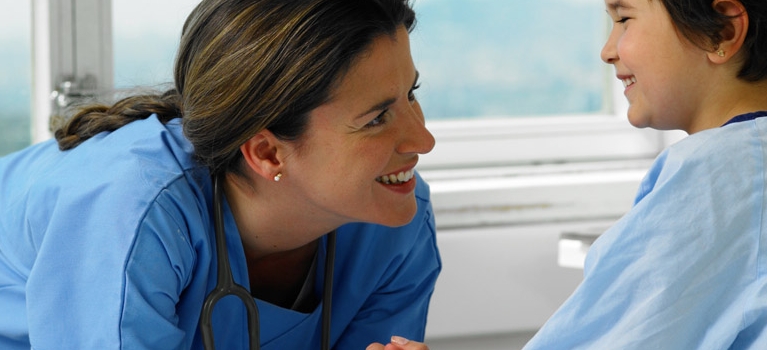 Nurse laughing with boy patient